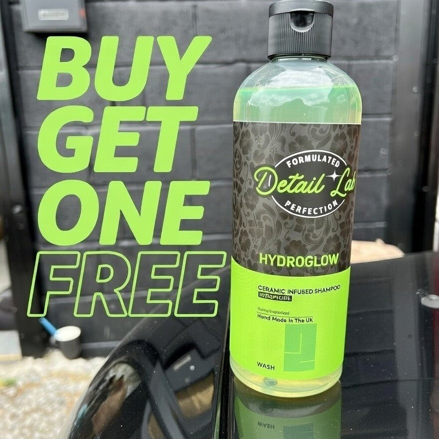 Bottle of 'Hydroglow' ceramic infused shampoo with promotional text on a car window.