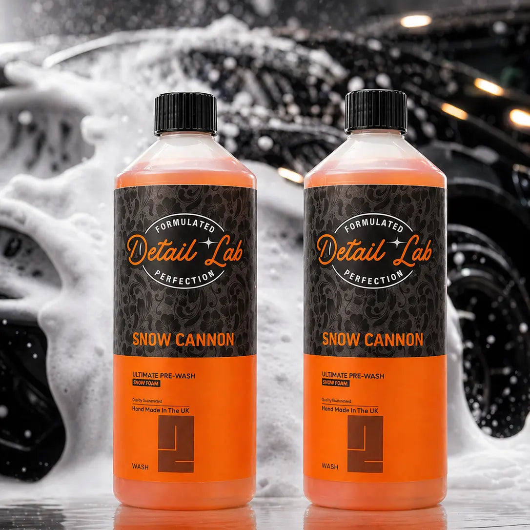 Two bottles of Detail Lab Snow Cannon product with a snowy car background