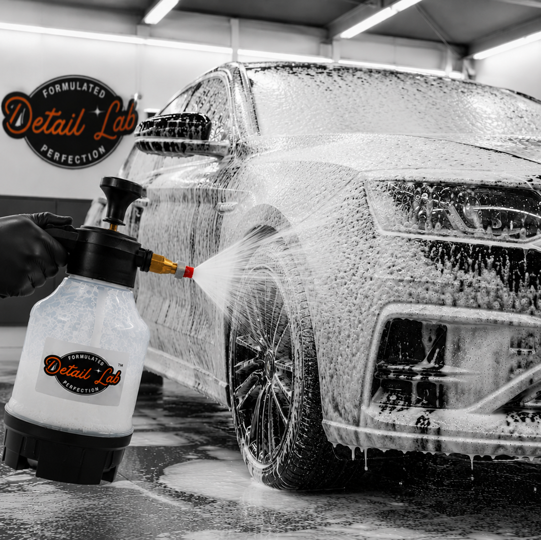 Car being washed with a soapy solution in a garage, using Detail Lab products.