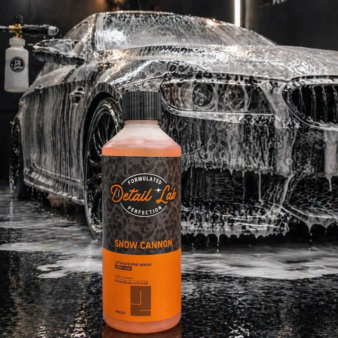 Bottle of Detail Lab Snow Cannon product in front of a car being washed